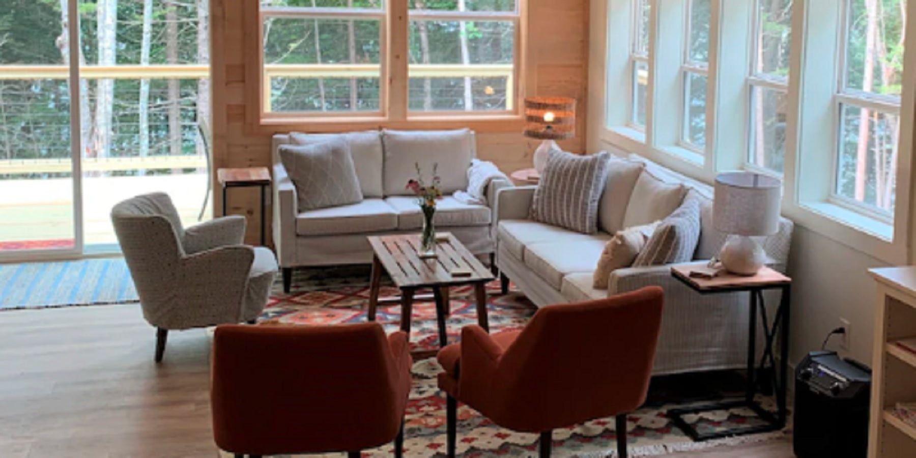 A sitting nook in a kitchen furnished with chairs and couches with stain resistant upholstery fabrics