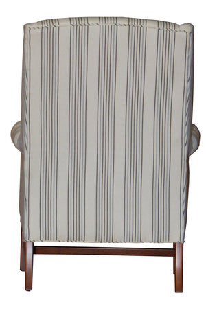 A carmel wingback chair in a striped fabric