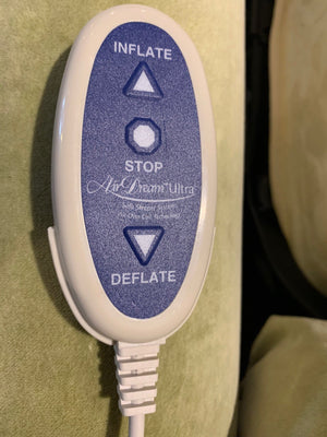 close up showing control wand for air dream sleep mattress on condo sized Douglas sleeper